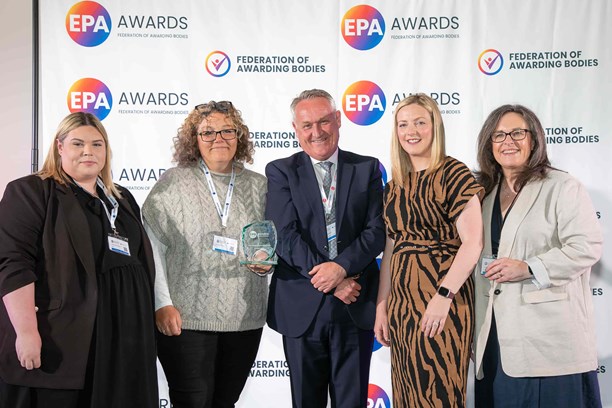Individuals from NCFE pose with the award